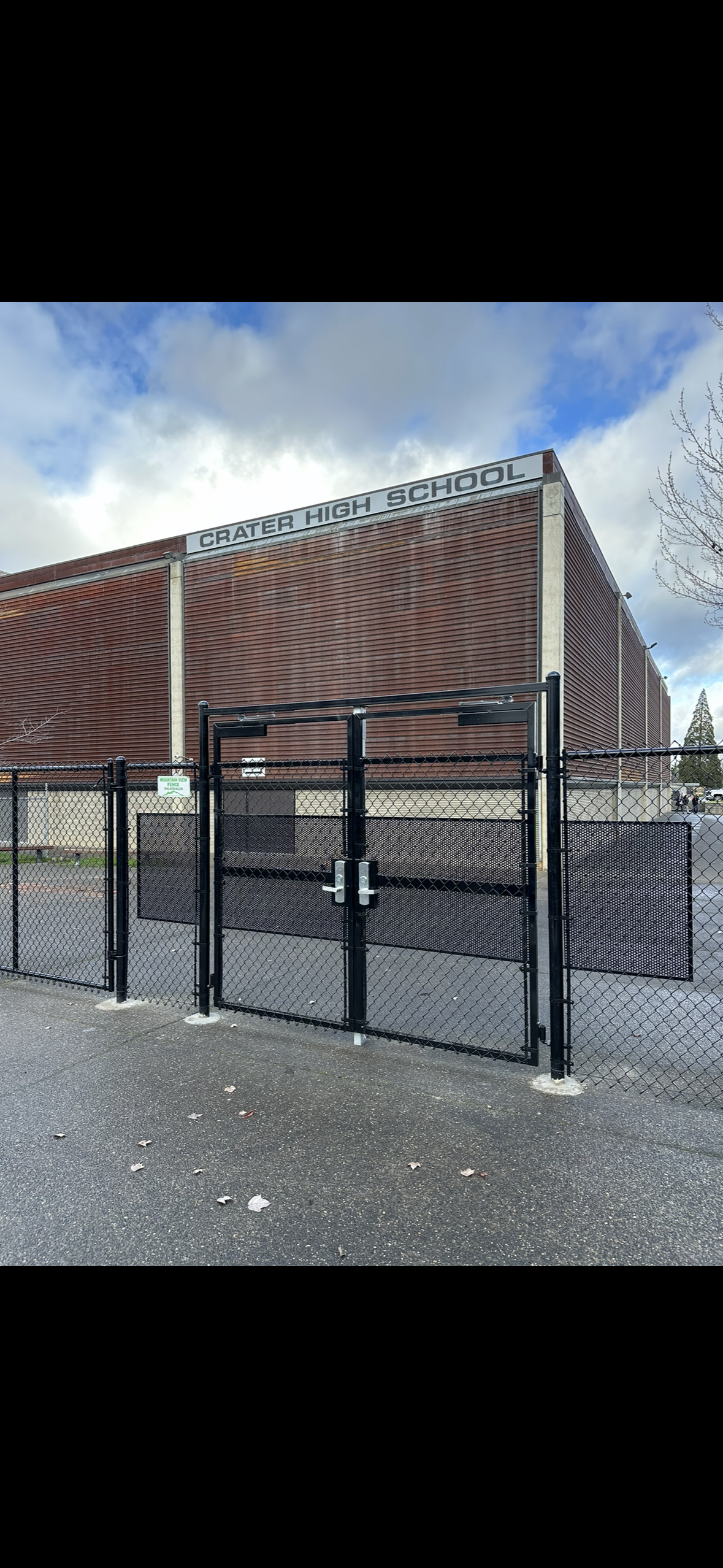 Crater High School in Central Point, Oregon, features a chain-link perimeter fence with a double pedestrian gate system equipped with panic bars