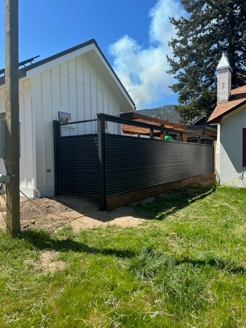 Custom horizontal black corrugated panel fence built by Mountain View Fence