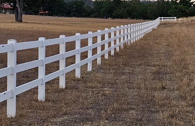 Three rail ranch style white Vinyl fencing on acreage near Central Point, Oregon
