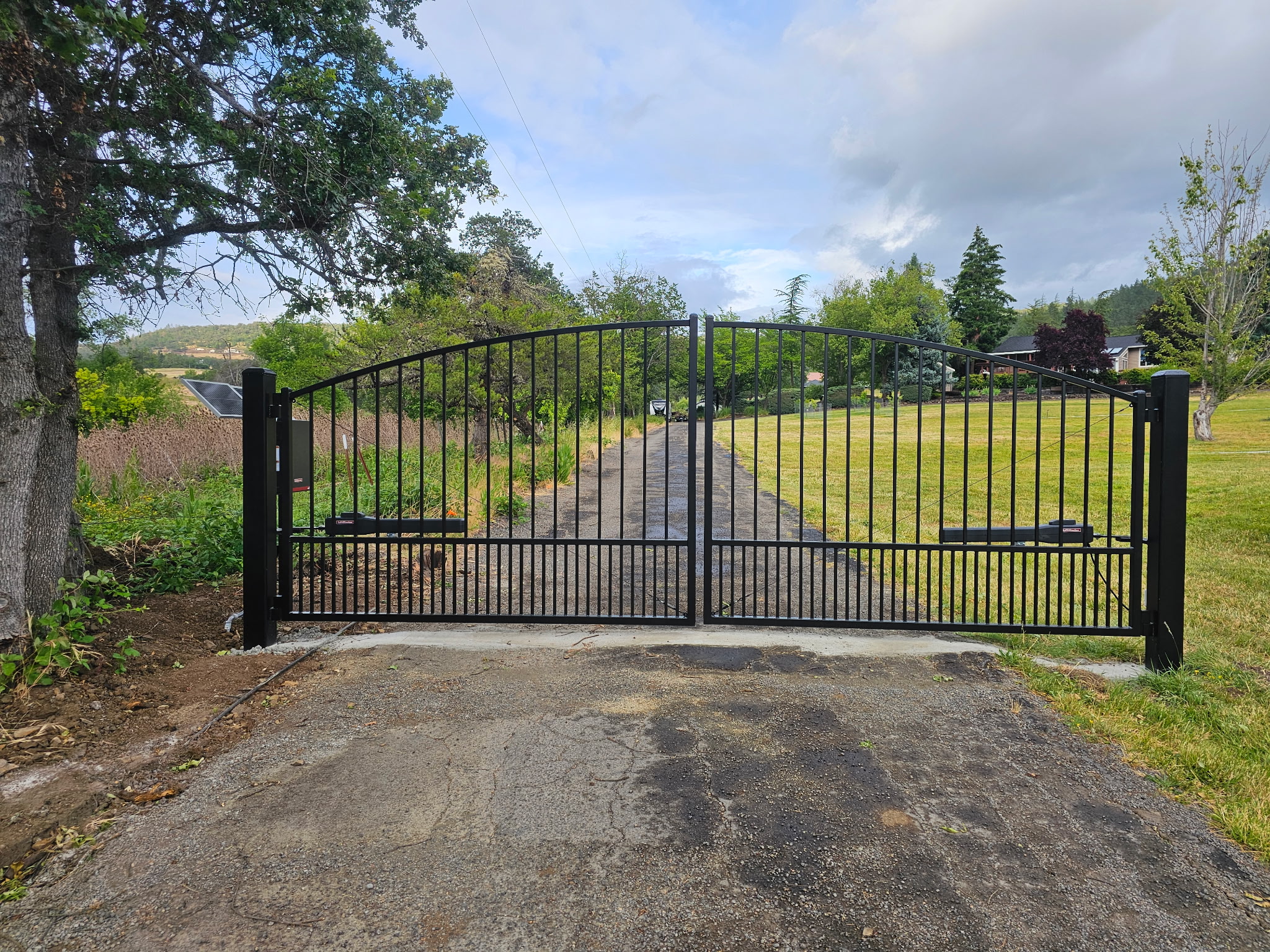 Regal style arched top Ornamental Iron double swing Automatic Gate near Medford