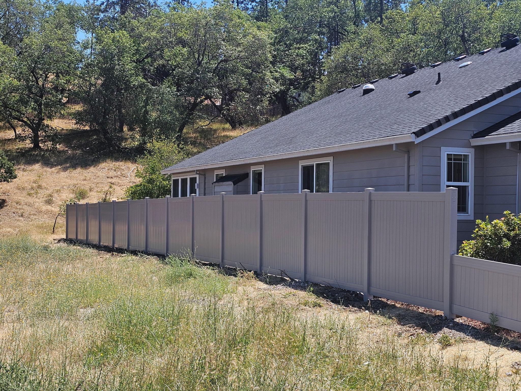 Gray solid style Vinyl fence installed at a Jackson County, Oregon home