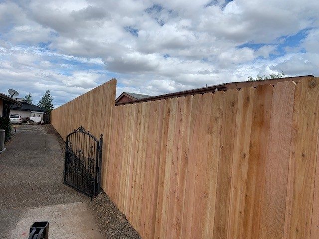 6'-8' High Dog Eared Cedar Fence Installed on Postmaster Galvanized Steel Posts