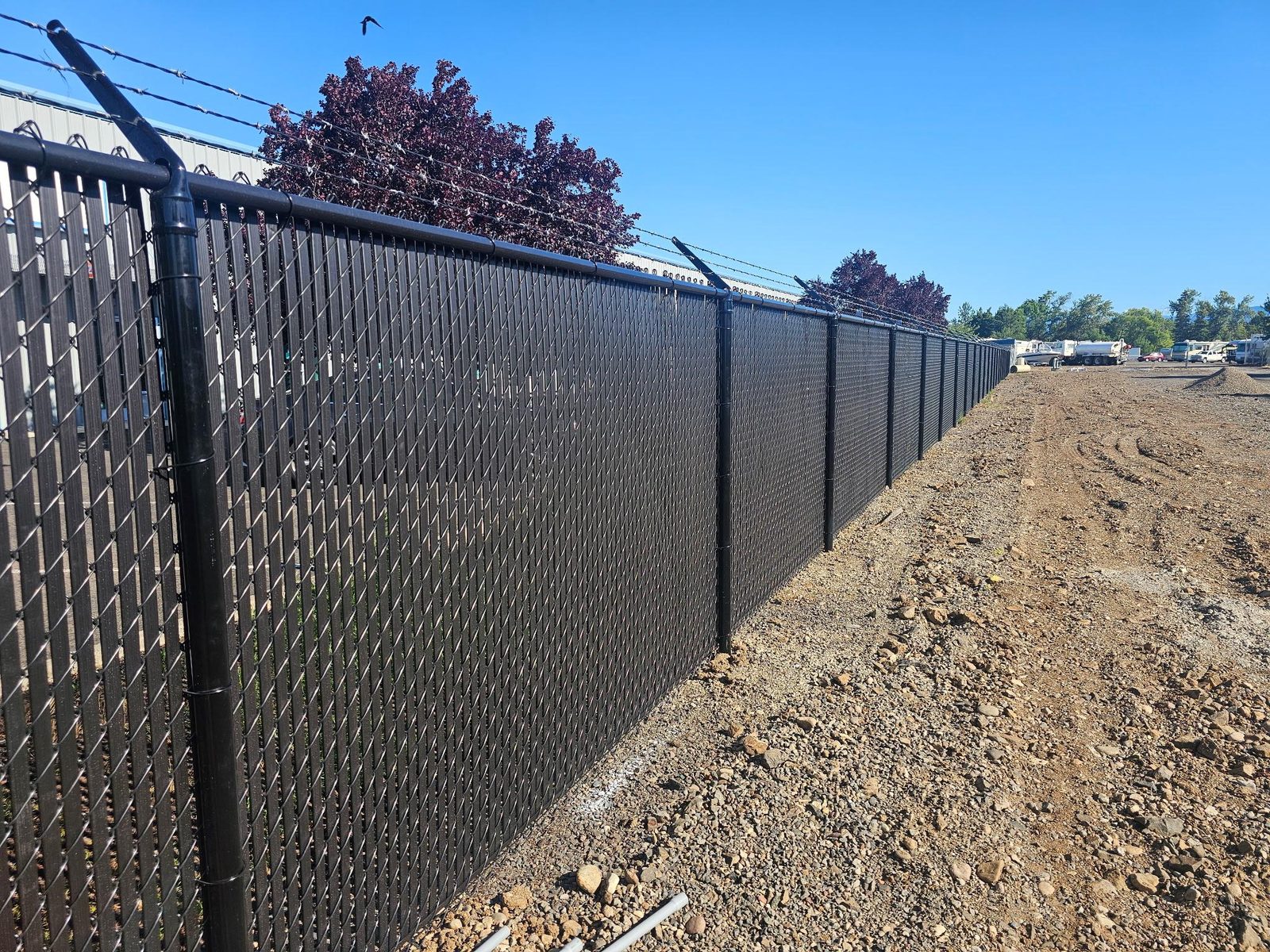 6' High Black Chain Link with 3 Strands of Barbed Wire on Top & Black Privacy Slat Inserts
