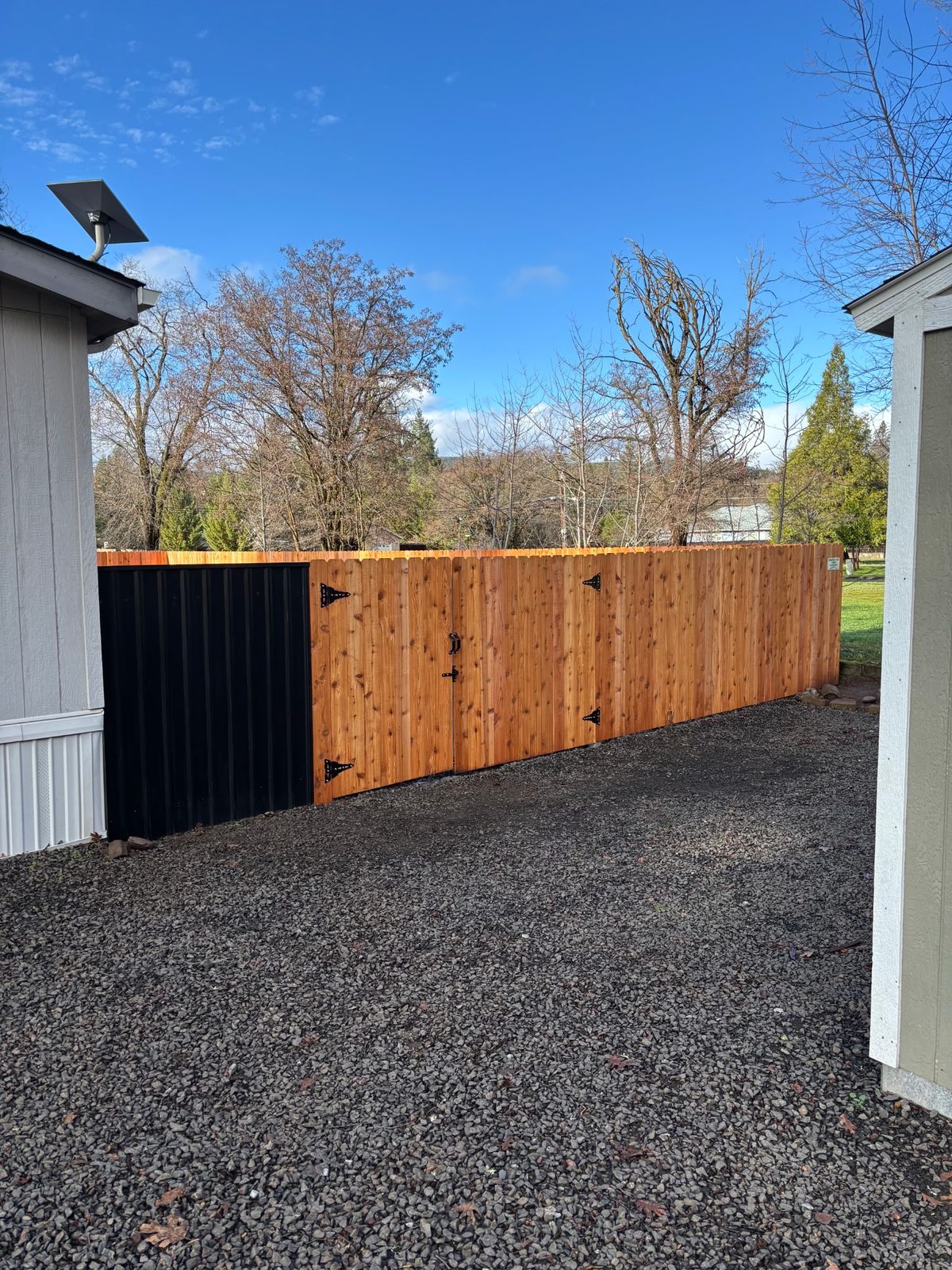 6' High Dog Eared Cedar Fence with Non-Combustible Steel Panel Next to House for Fire Safety