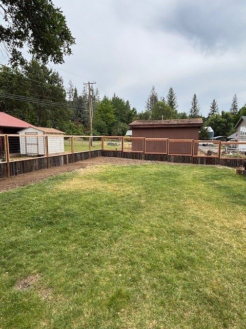 6' High Fence with a 4' High Grid Style Fence with Repurposed Old Fence Boards as the Bottom 2'