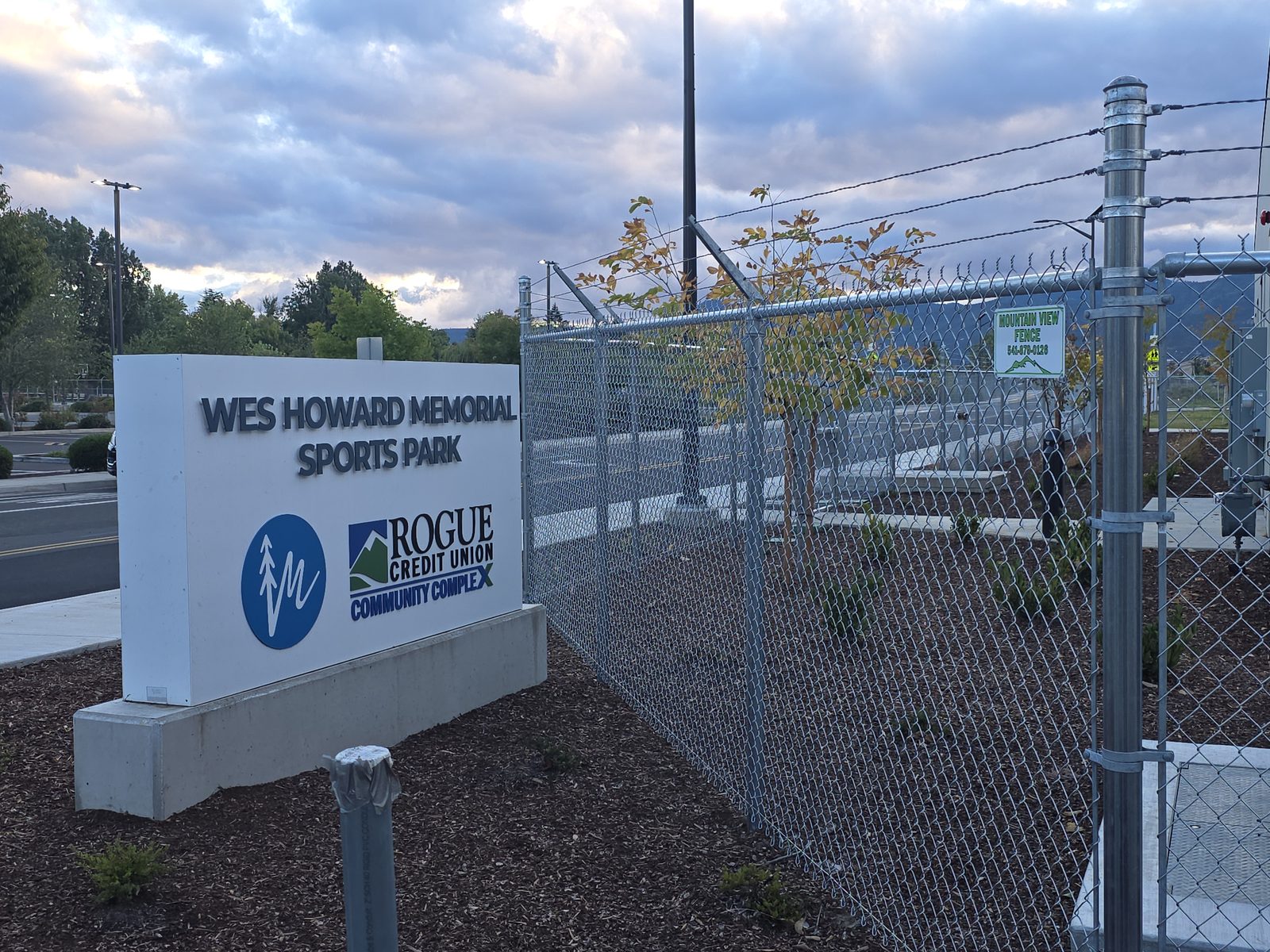 6' High Galvanized Chain Link with Angled Barbed Wire on Top