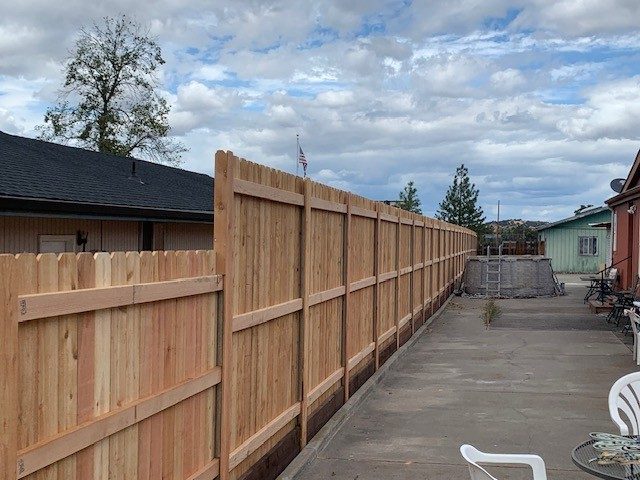 Back Side of 6'-8' High Dog Eared Cedar Fence Installed on Postmaster Galvanized Steel Posts