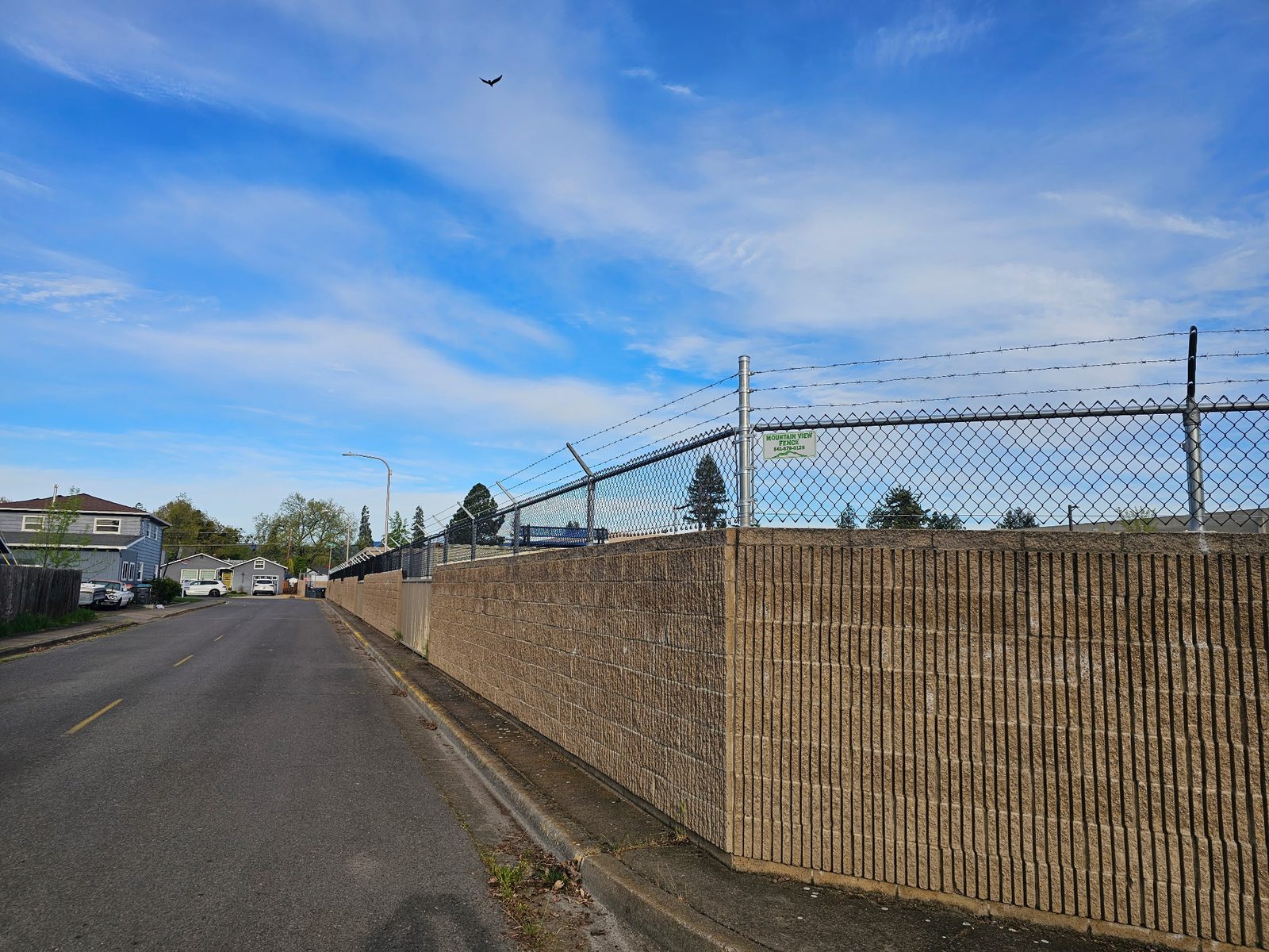 Chain Link with 3 Strands Barb Wire Mounted on Block Wall for Added Security