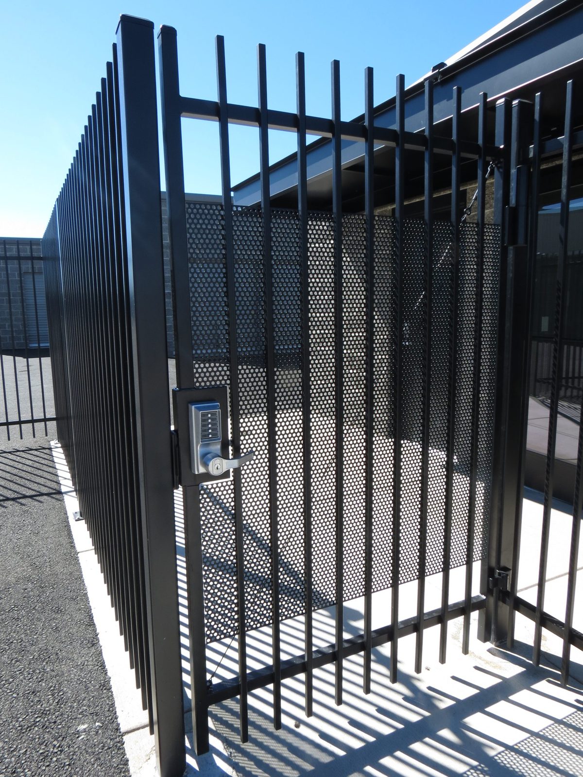 6' high Ornamental Iron security gate with anti-tamper perf plate and keypad entry