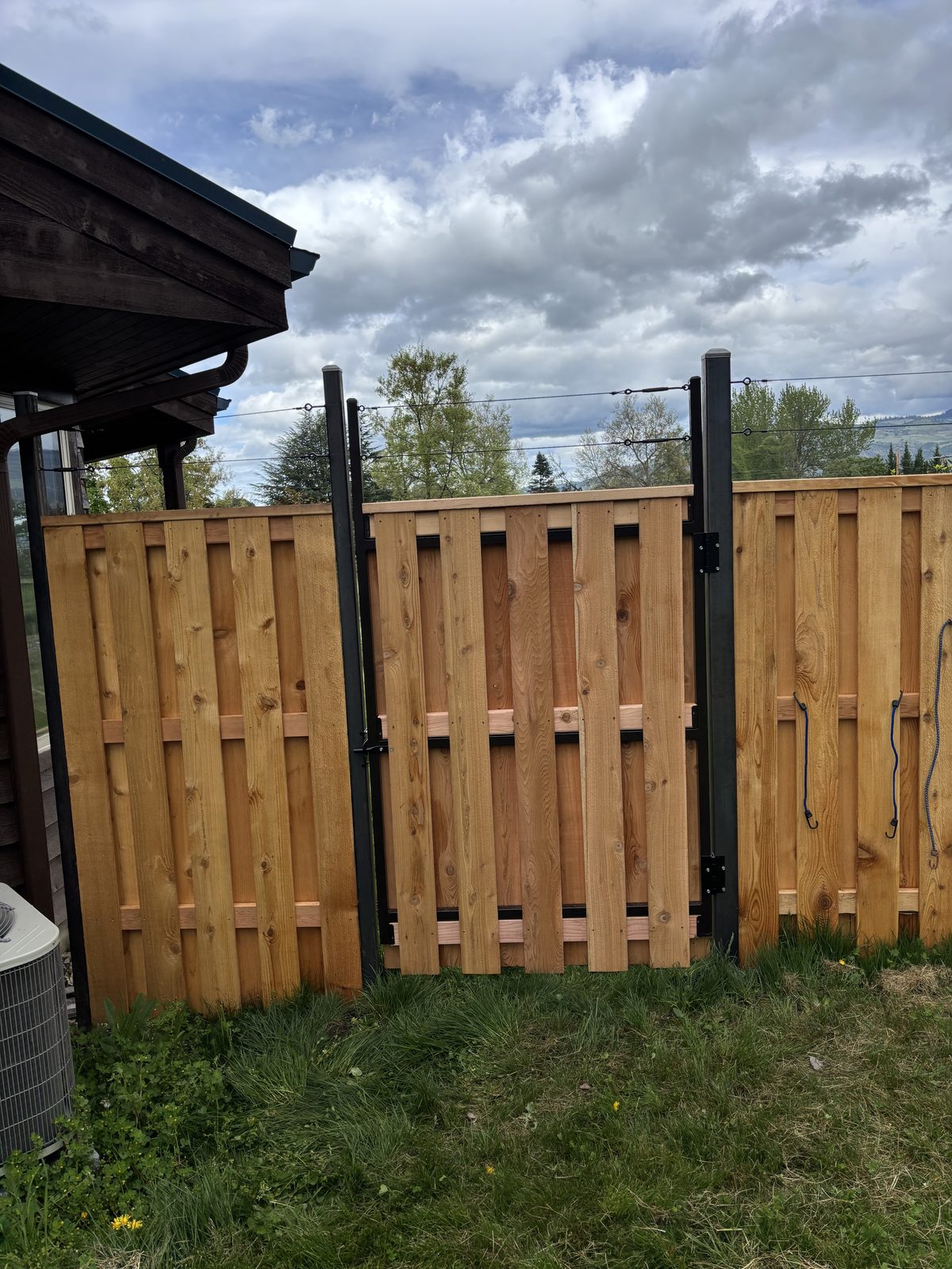 Good Neighbor Alternating Cedar Board Fence on Powder Coated Posts with Stainless Steel Cabling Above