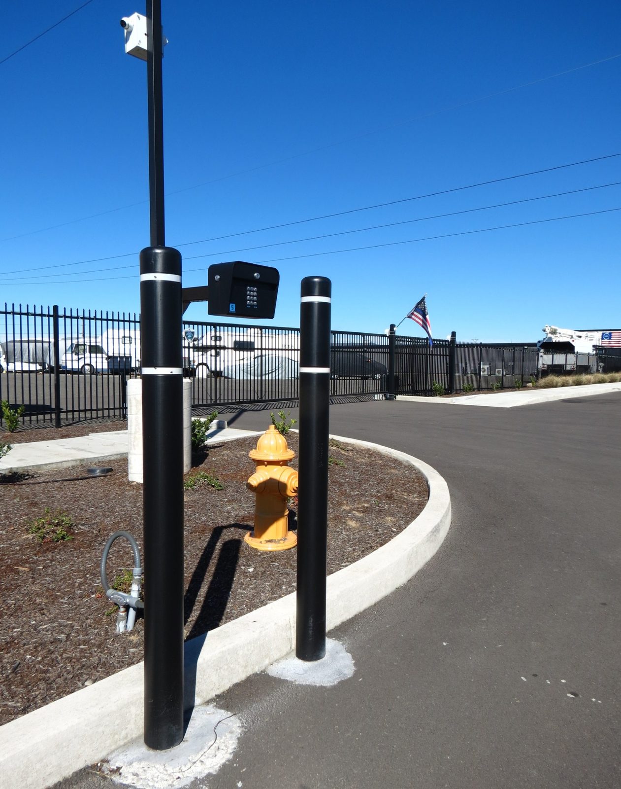 Large Bollards with PVC Sleeves to Protect Keypad
