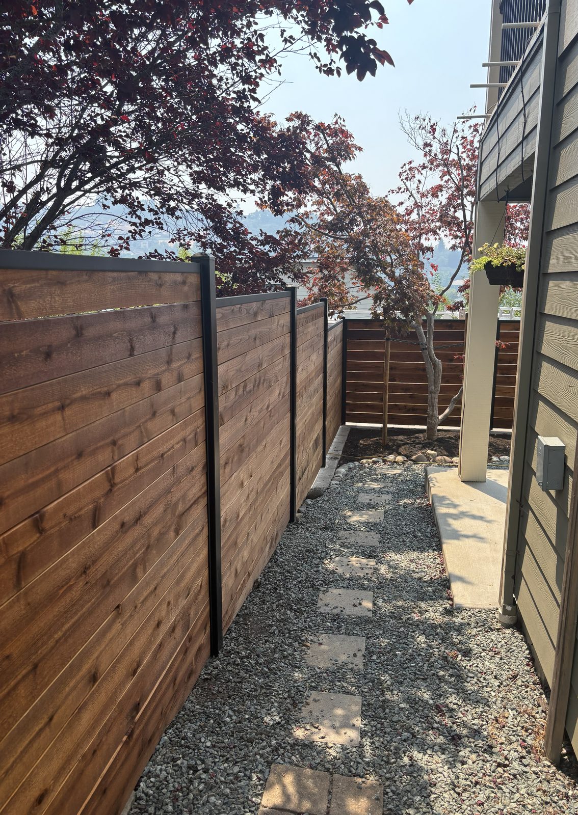 Stained Horizontal Board Fence with Black Powder Coated Steel Posts